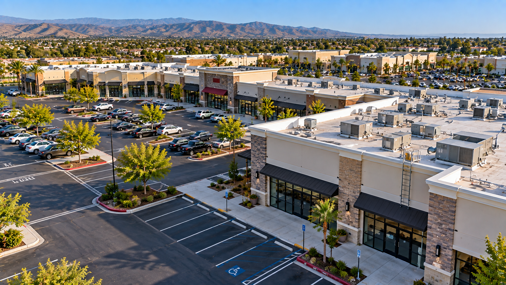 Aerial view of a large shopping center and parking areas