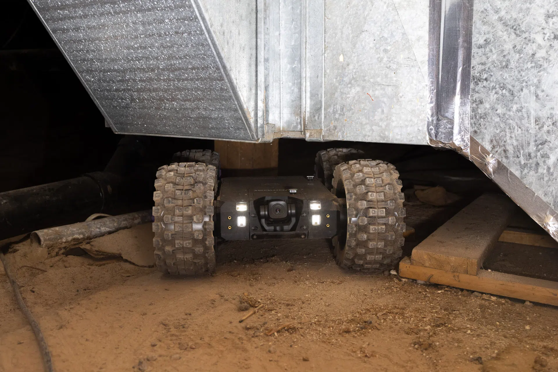1. Crawlspace inspection robot evaluating an inaccessible area beneath a home
